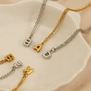 Chic gold and silver initial pendants displayed on a ceramic tray for DIY jewelry projects