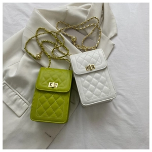 Detail of green and white quilted chain bags with golden adjustable ball metal buckles
