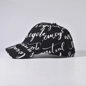 Distressed black baseball cap with all-over white artistic text print in street style