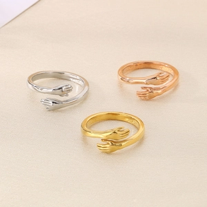 Minimalist stainless steel embrace hug rings shown in silver, gold, and rose gold finishes