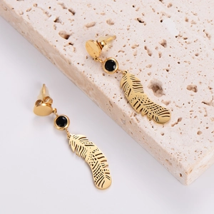 Minimalist gold feather drop earrings with round black gemstone and cutout metal design