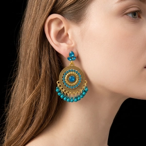 Vintage bohemian gold earrings with blue rhinestones and beads in a flower design