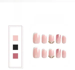 Close-up of assorted French tip press-on nails in pink and white with glitter and rhinestones