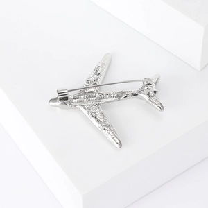 Detailed back view of silver airplane brooch showing secure pin clasp mechanism