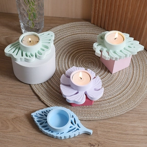 Pastelkleurige hars kandelaars in bladvorm op een houten tafel voor decor