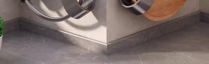 Close-up of marble texture wall corner trim with minimalist aluminum edge profile