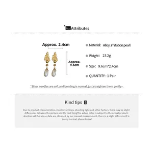 Detailed view of vintage gold flower and teardrop pearl earrings with size 9.6cm x 2.4cm
