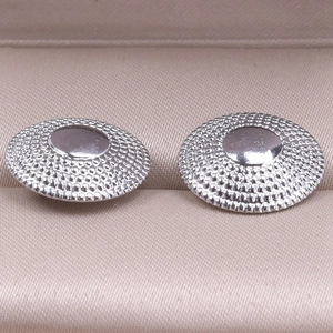 Macro shot of 304 stainless steel round earrings with textured beaded edges in a gift box