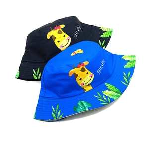 Detail of children's bucket hats featuring cartoon giraffe prints and breathable cotton fabric