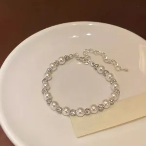 Elegant pearl bracelet with silver hollow metal beads and adjustable lobster clasp