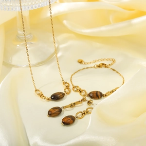Retro stainless steel jewelry set with golden finish and brown tiger eye stone pendants