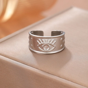 Macro view of matte stainless steel adjustable ring with embossed evil eye motif