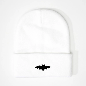 Close-up of the detailed black bat embroidery on the white ribbed knitted beanie hat