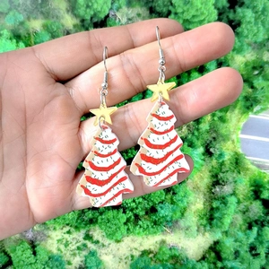 Festive Christmas tree earrings with red white stripes and gold star in hand display
