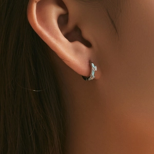 Elegant s925 silver hoop earrings with light blue butterfly enamel on a female model