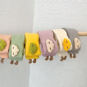 Detail of soft knit toddler scarves featuring cute tree embroidery and 3D feet design