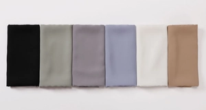 Detailed flat lay of six smooth satin headscarves in black, grey, khaki and olive colors