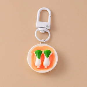 Detailed view of creative keychain featuring miniature bok choy on a white ceramic plate