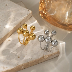 Minimalist stainless steel ball rings in gold and silver finish with leaf shadow
