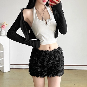 Detail of a chic black mini skirt featuring realistic 3D fabric flower appliques