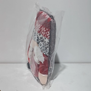 Macro shot of 3D Christmas gnome chair cover in festive red and grey with plush white beard
