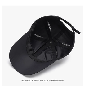 Detail of breathable mesh interior and adjustable silver metal buckle on black baseball cap