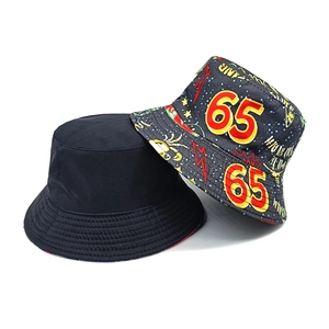 Reversible bucket hat with vintage number 65 graffiti print and solid black cotton fabric