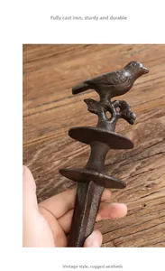 Close-up of a sturdy cast iron bird hose holder with a vintage brown rustic texture finish