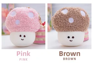 Close-up of pink and brown plush mushroom keychains with embroidered smiley faces