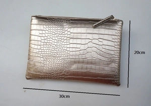 Flat lay of metallic crocodile texture envelope clutch bag with 30cm by 20cm dimensions