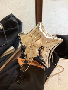 Close-up of star-shaped crossbody bag with rhinestone fringes and silver mirror surface