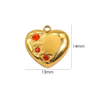 Macro detail of heart pendant in gold finish with red stars, size 13mm by 14mm