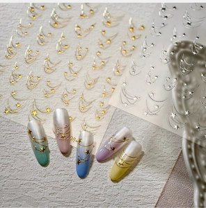 Detail view of gold and silver star moon nail stickers on iridescent gradient press-on nails