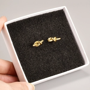 Minimalist knot design 18K gold plated titanium steel stud earrings on display box