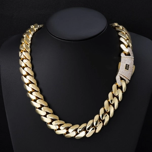 Close-up of 14K gold Cuban link chain with iced-out S-letter clasp on a neck display