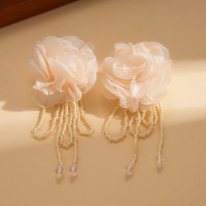 Detail of elegant chiffon flower earrings with beaded tassels and glass crystal drops