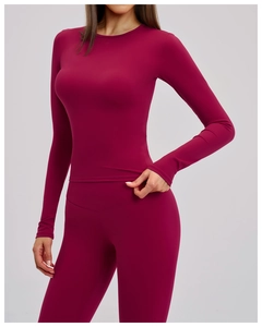 Close-up of deep red high-stretch yoga set featuring long-sleeve top and high-waisted leggings