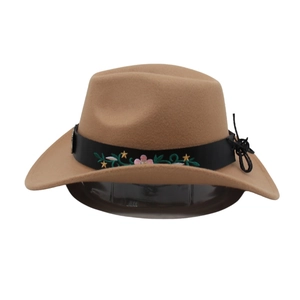 Detail of khaki wool fedora hat featuring floral embroidery on a black leather band