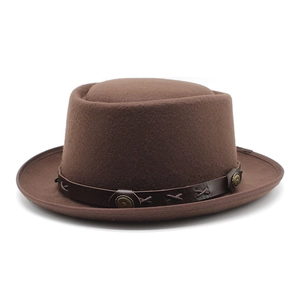Detail of dark brown wool pork pie hat with leather band and vintage metal buckle