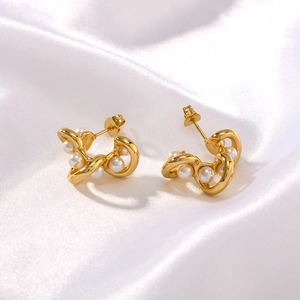 Elegant C-shaped stainless steel hoop earrings with pearls on white silk