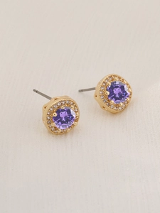 Detailed macro view of a gold-plated halo stud earring with a round purple zircon stone