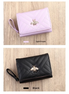Detail of short PU leather wallets featuring V-quilted texture and gold bee hardware decoration