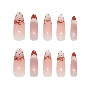 Pink gradient almond press-on nails with red French tips, bows and polka dots