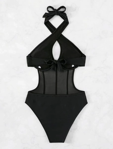 Detail of black cutout swimsuit featuring mesh panels and decorative bows