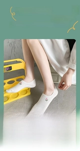 Detailed view of white cotton low cut socks featuring delicate pink tulip embroidery detail