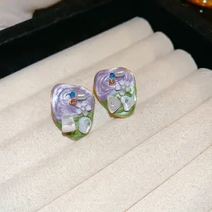 French vintage floral stud earrings with purple enamel and gold edging on velvet