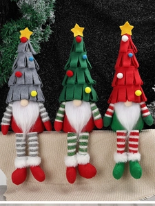 Three Christmas gnomes with tree hats and striped long legs sitting in a holiday row