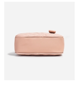 Detail view of pink quilted leather camera bag with fine stitching and top zipper closure