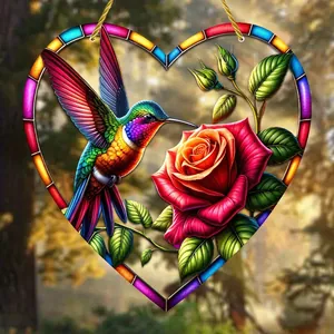 Detail of heart suncatcher featuring a hummingbird and red rose for garden decor