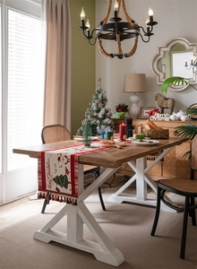 Detailed close-up of festive jacquard table runner with red plaid and snowman patterns